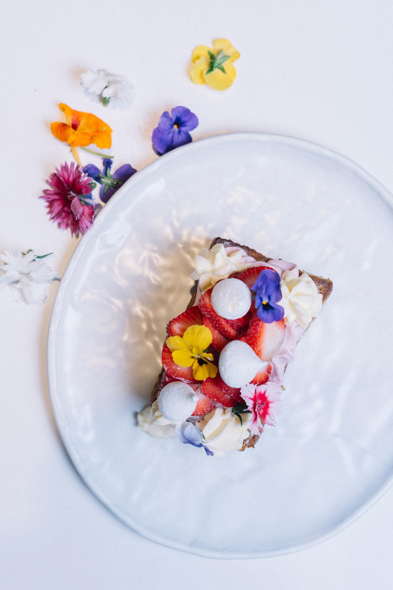 Detail of plated dessert with edible flowers